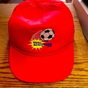 Red Y2K 90’s trucker hat.  Goal Achievers 1994